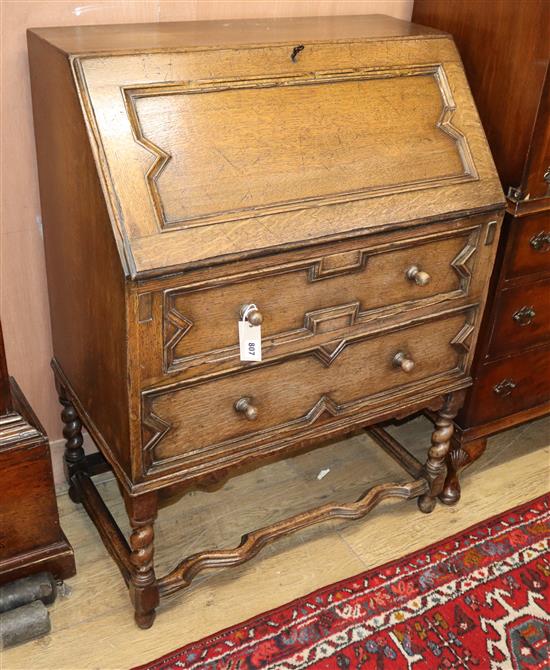 A Jacobean style oak bureau with geometric moulding W.76cm